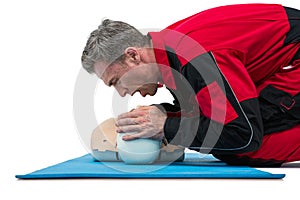 Paramedic blowing oxygen to dummy