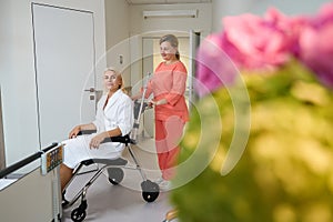 Paramedic brought a lady to a hospital room in wheelchair