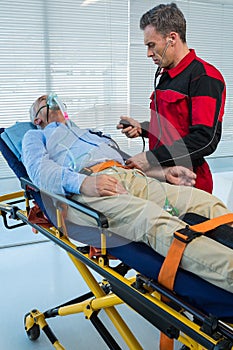 Paramedic checking blood pressure of patient