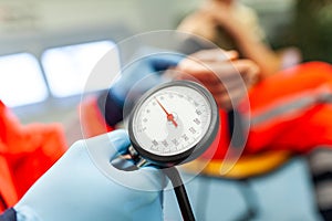 Paramedic checks the blood pressure of a patient