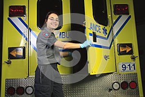 Paramedic, closing the door of the ambulance