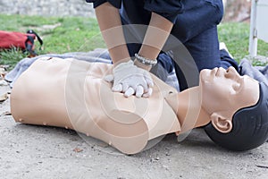 Paramedic demonstrates CPR on a dummy