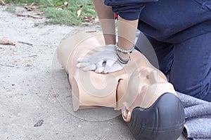 Paramedic demonstrates CPR on a dummy