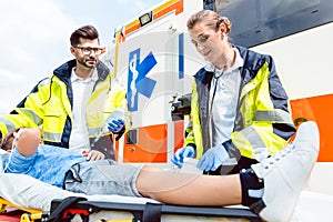 Paramedic and emergency doctor caring for injured boy