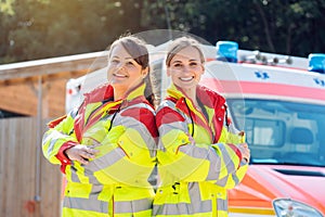 Paramedic and emergency doctor in front of ambulance