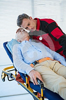 Paramedic examining the patient