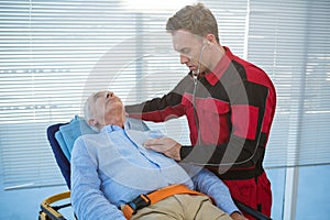 Paramedic examining the patient