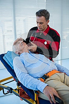 Paramedic examining the patient