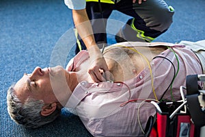 Paramedic examining a patient during cardiopulmonary resuscitation