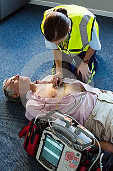 Paramedic examining a patient during cardiopulmonary resuscitation