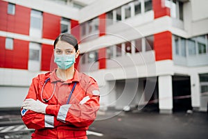 Paramedic in front of isolation hospital facility.Coronavirus Covid-19 heroes.Mental strength of medical professional.Emergency