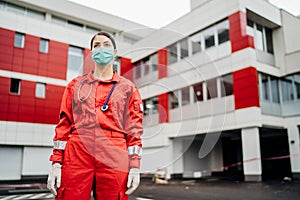 Paramedic in front of isolation hospital facility.Coronavirus Covid-19 heroes.Mental strength of medical professional.Emergency