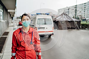 Paramedic in front of isolation hospital facility.Coronavirus Covid-19 heroes.Mental strength of medical professional.Emergency