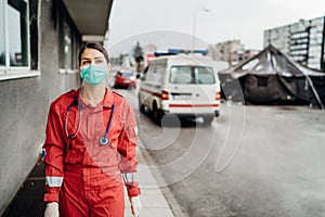 Paramedic in front of isolation hospital facility.Coronavirus Covid-19 heroes.Mental strength of medical professional.Emergency