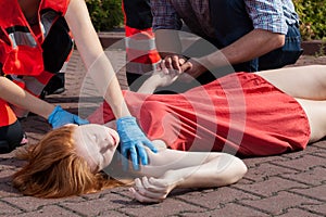 Paramedic helping unconscious woman