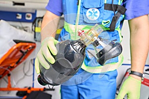 Paramedic holds an air breathing bag in his hands