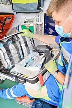 Paramedic holds in his hands a set for first aid