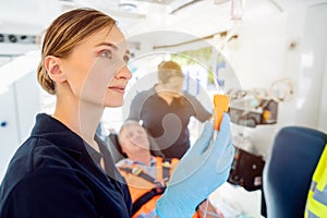 Paramedic looking after the drop injection in an ambulance