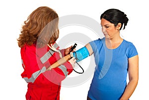 Paramedic measure blood pressure to woman