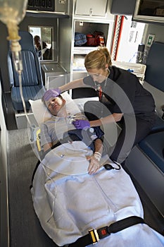 Paramedic with patient in ambulance