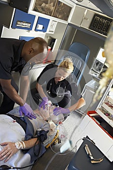 Paramedic with patient in ambulance