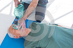 Paramedic performing resuscitation on patient