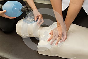 Paramedic practicing Cardiopulmonary resuscitation, CPR on a dum