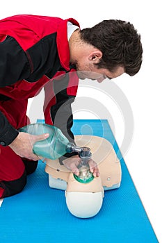 Paramedic practicing cardiopulmonary resuscitation on dummy