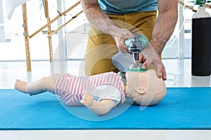 Paramedic practicing cardiopulmonary resuscitation on dummy