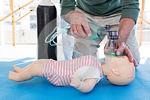 Paramedic practicing resuscitation on dummy