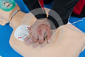 Paramedic practicing resuscitation on dummy