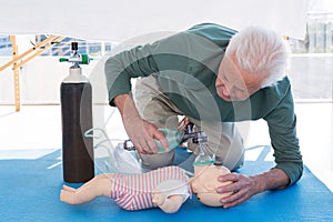 Paramedic practicing resuscitation on dummy