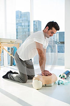 Paramedic practicing resuscitation on dummy