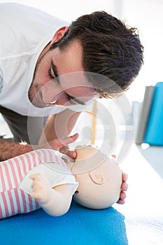 Paramedic practising resuscitation on dummy