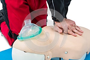 Paramedic practising resuscitation on dummy