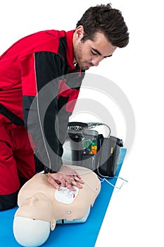 Paramedic practising resuscitation on dummy