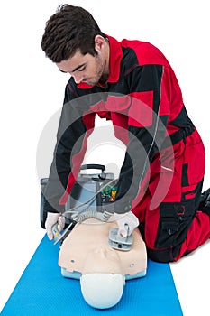 Paramedic practising resuscitation on dummy