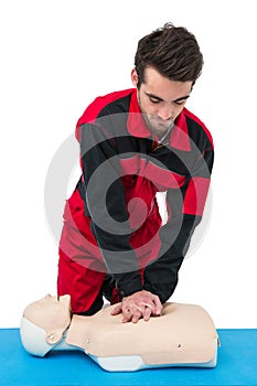 Paramedic practising resuscitation on dummy