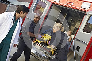 Paramedic preparing to unload patient