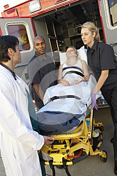 Paramedic preparing to unload patient