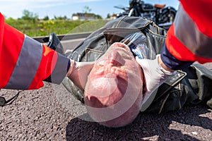 Paramedic removes an helmet from an injured biker