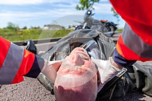 Paramedic removes an helmet from an injured biker