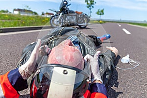 Paramedic removes an helmet from an injured biker