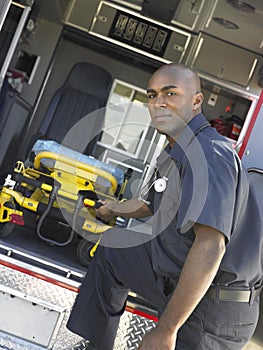 Paramedic removing gurney from ambulance