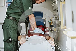 Paramedic resuscitating a patient in an ambulance