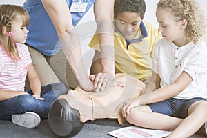 Paramedic showing children chest compressions