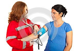 Paramedic taking blood pressure