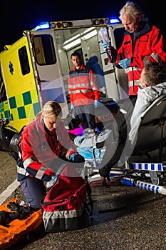 Paramedic team assisting injured motorbike driver