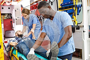 Paramedic team moving man on stretcher