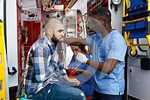 Paramedic team providing first aid to man